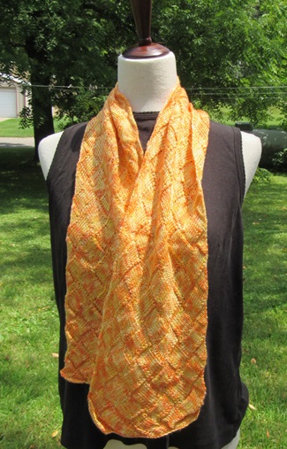 a bight knit yellow and orange scarf with a check pattern